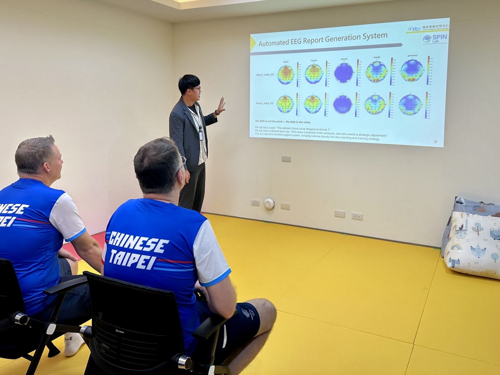 A sport-science researcher discussing evidence with practitioners